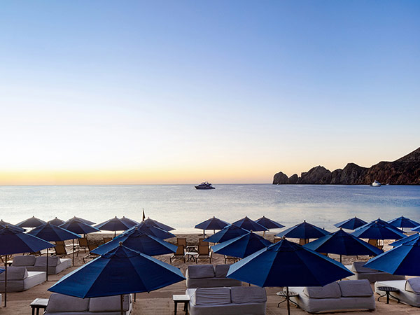 Lounge Chairs And Umbrellas On The Beach.